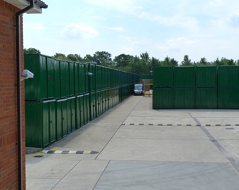 Ranks of green storage containers at the Eversley site