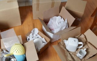 Cardboard boxes full of kitchenware - storage top tips